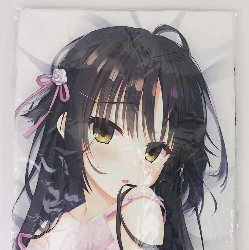 Anime-style illustration of a girl with long black hair, yellow eyes, pink ribbon, and pink outfit, seen through clear packaging.