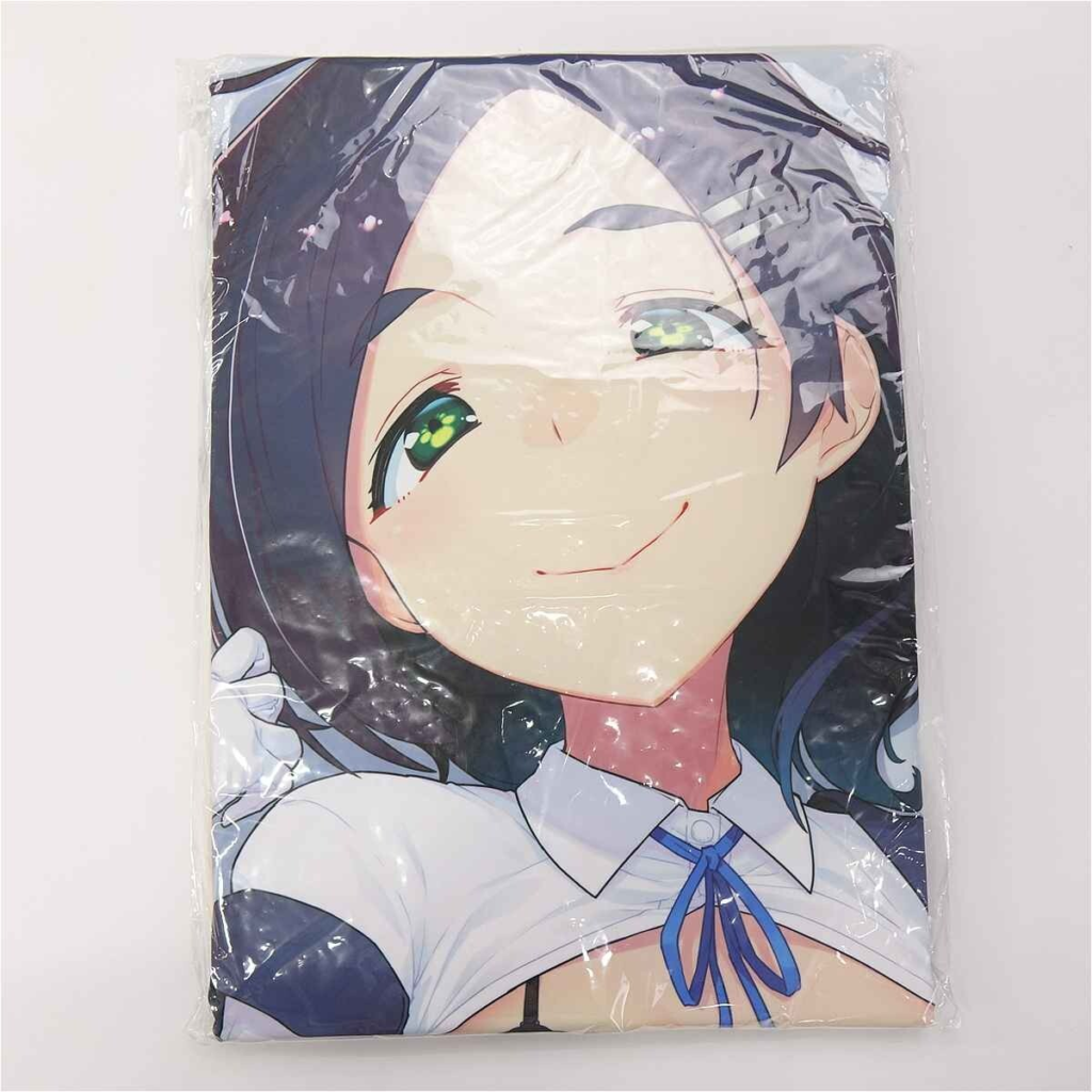 Packaged anime pillow cover showing a smiling girl with dark hair and green eyes, wearing a white top with a blue ribbon.