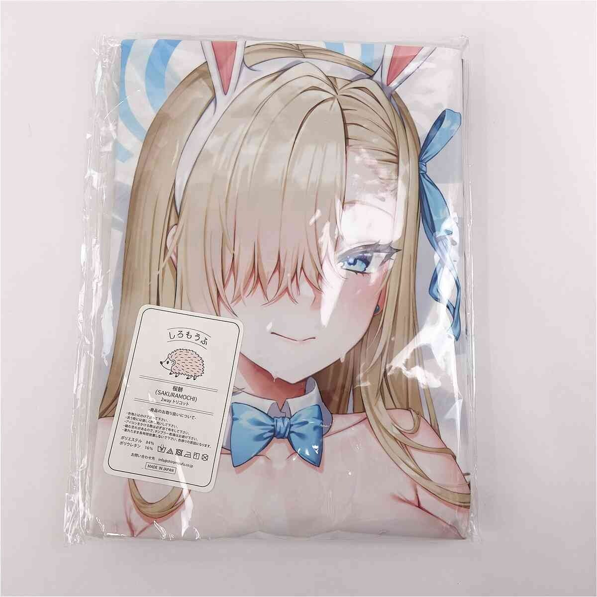 Packaged dakimakura cover showing a blonde anime girl with blue bow and bunny ears in plastic wrap.