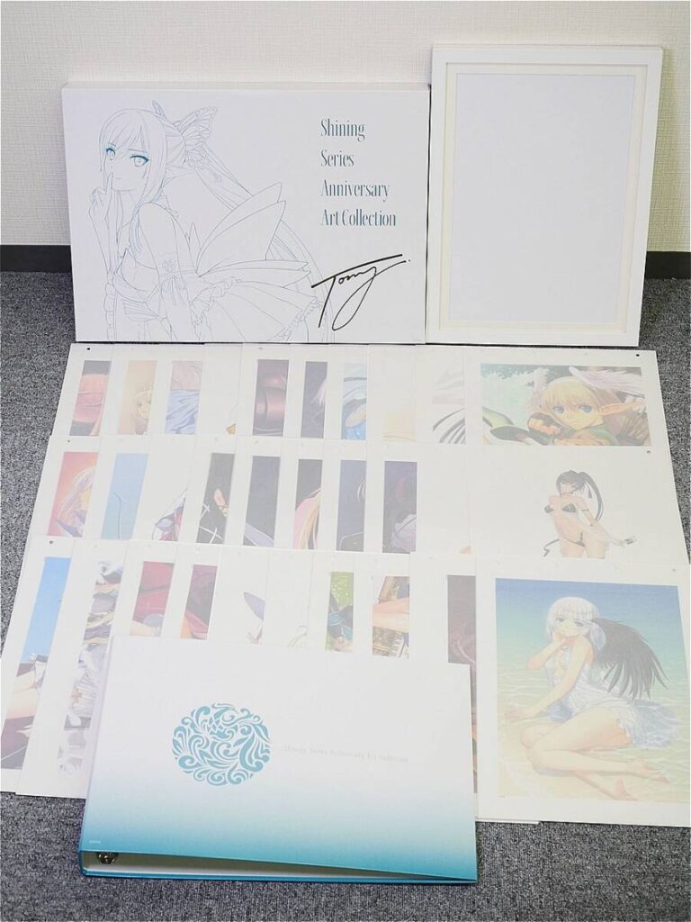i-img900x1200-17755404585888dbshja27921 - 【絵巻本舗】二次元イラストグッズ特化型買取専門店 Boxed anime art collection spread on carpet: white box with 'Shining Series Anniversary Art Collection' and signature, plus loose art sheets and a framed insert nearby.