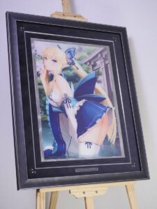 Framed anime illustration of a blonde girl in a blue and white outfit with a butterfly hair accessory, kneeling in water with a garden backdrop.