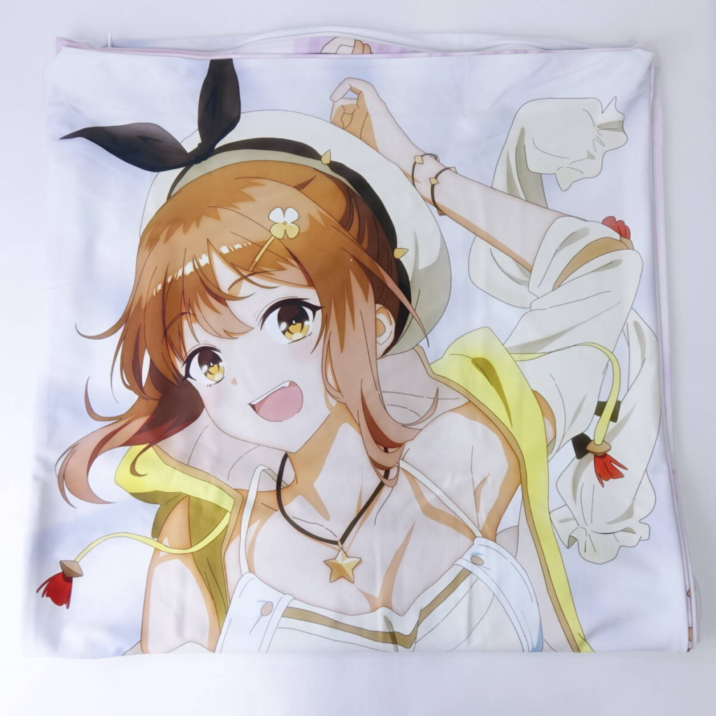 Anime-style girl with brown hair and a hat, smiling, on a white blanket with yellow accents.