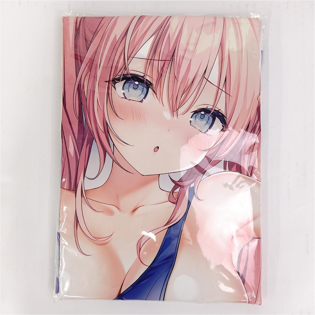 Close-up of an anime girl with pink hair and blue eyes, wearing a blue top, looking softly at the viewer.