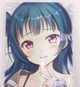 Close-up of an anime-style girl with blue hair and pink eyes, blushing and smiling, her hand near her chin.