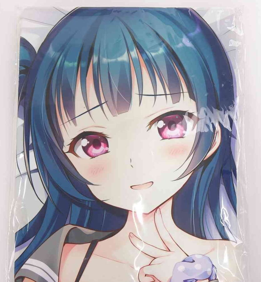 Close-up of an anime-style girl with blue hair and pink eyes, blushing and smiling, her hand near her chin.